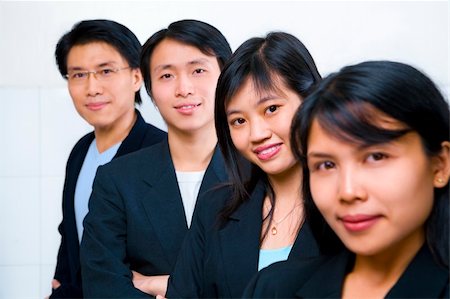 Young Asian business people line up, with focus on the second front woman (Chinese woman) Stock Photo - Budget Royalty-Free & Subscription, Code: 400-05117225