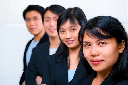 Young Asian business people line up, with focus on the front woman (South East Asian woman) Stock Photo - Budget Royalty-Free & Subscription, Code: 400-05117226