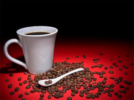 simsearch:400-06701416,k - A cup of tasty coffee and some coffee beans spread arround. Stock Photo - Budget Royalty-Free & Subscription, Code: 400-05117605