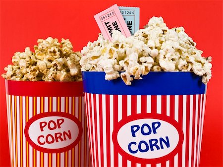 simsearch:400-04913050,k - Two popcorn buckets over a red background. Movie stubs sitting over the popcorn. Photographie de stock - Aubaine LD & Abonnement, Code: 400-05117608
