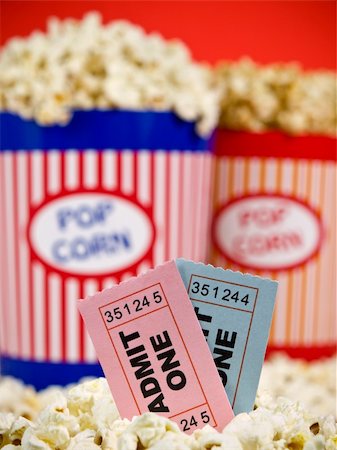 simsearch:400-04913050,k - Two popcorn buckets over a red background. Movie stubs sitting over the popcorn. Photographie de stock - Aubaine LD & Abonnement, Code: 400-05117611