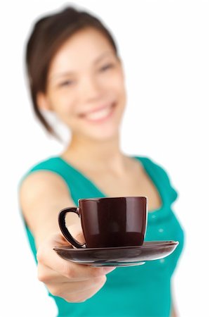 Beautiful young woman with big smile serving an espresso. Cup is sharp, model out of focus. Isolated on white. Stock Photo - Budget Royalty-Free & Subscription, Code: 400-05118002