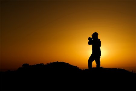 film camera silhouette - A silhouette of cameraman with golden light in the morning. Stock Photo - Budget Royalty-Free & Subscription, Code: 400-05118971