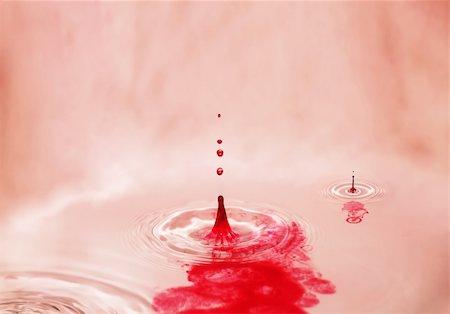 photography paint pigments - Red splashes in clear water givings broad patterns, very showily and originally. Bright beige background. Much place is for inscriptions Stock Photo - Budget Royalty-Free & Subscription, Code: 400-05118996