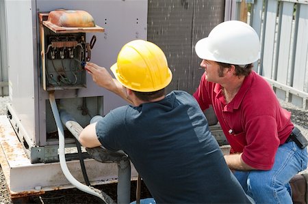 students working with tools - Two AC technicians repairing an industrial air conditioning compressor. Stock Photo - Budget Royalty-Free & Subscription, Code: 400-05119005