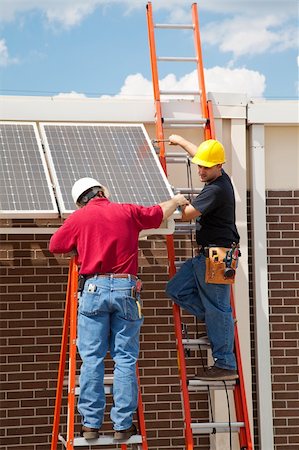 simsearch:400-05380326,k - Construction electricians installing solar panels on the side of a building. Stock Photo - Budget Royalty-Free & Subscription, Code: 400-05119006