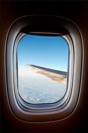 An airplane window with wing and cloudscape Stock Photo - Budget Royalty-Free & Subscription, Code: 400-05119750
