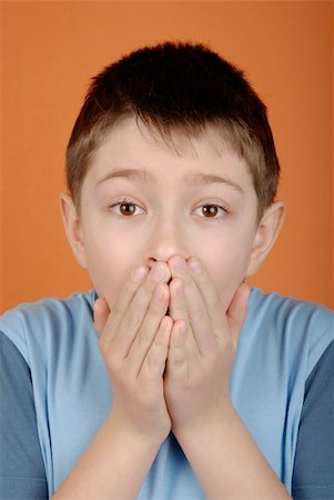 Portrait of scared boy on an orange background Stock Photo - Budget Royalty-Free & Subscription, Code: 400-05110412