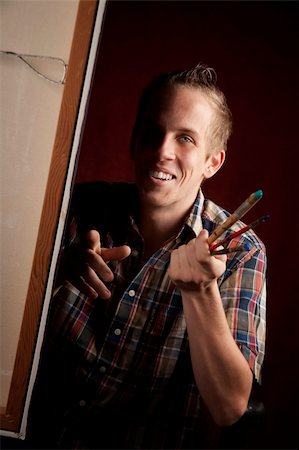 Handsome young artist holding brushes Stock Photo - Budget Royalty-Free & Subscription, Code: 400-05111247