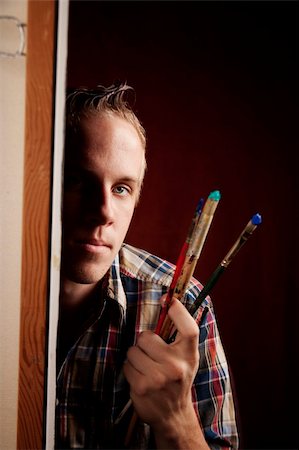 Handsome young artist holding brushes Stock Photo - Budget Royalty-Free & Subscription, Code: 400-05111248