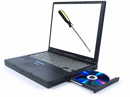 simsearch:400-03909479,k - Isolated black laptop with a DVD in tray and an isolated screwdriver on the screen. Foto de stock - Super Valor sin royalties y Suscripción, Código: 400-05111710