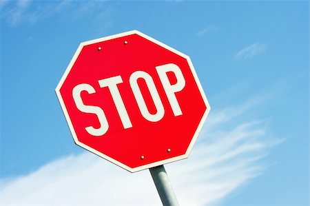 Closeup of a stop sign against clear blue sky Stock Photo - Budget Royalty-Free & Subscription, Code: 400-05112665