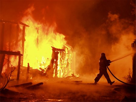 fight fires - burning building at night with fireman fighting with flame Stock Photo - Budget Royalty-Free & Subscription, Code: 400-05113424