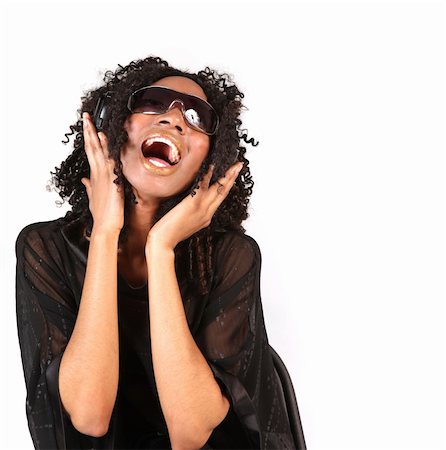 pedi - Black Woman Singing While Listening to Music on Headphones Photographie de stock - Aubaine LD & Abonnement, Code: 400-05125138