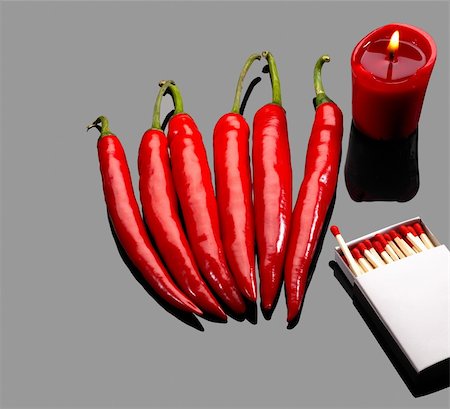 simsearch:400-05732421,k - fresh red chili peppers  with matches and lighted red candle over grey reflective surface Photographie de stock - Aubaine LD & Abonnement, Code: 400-05125645