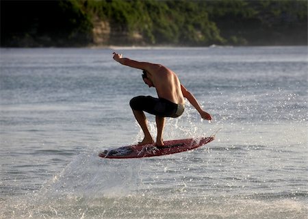 simsearch:400-07217949,k - Young men - the surfer in ocean. Dreamland beach - Bali. Indonesia. Foto de stock - Super Valor sin royalties y Suscripción, Código: 400-05125864