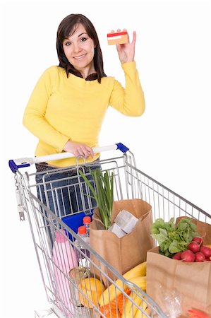 happy brunette woman with shopping cart. over white background Stock Photo - Budget Royalty-Free & Subscription, Code: 400-05126796