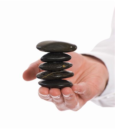 simsearch:400-07772579,k - A stack of meditation river rocks being held carefully by a meditating person, isolated against a white background Fotografie stock - Microstock e Abbonamento, Codice: 400-05126997