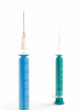 two syringes against clear white background taken from up close Stock Photo - Budget Royalty-Free & Subscription, Code: 400-05127292