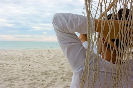 simsearch:400-05097844,k - Young man relaxing on the sand beach Stock Photo - Budget Royalty-Free & Subscription, Code: 400-05128181