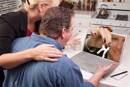 simsearch:400-05129327,k - Couple In Kitchen Using Laptop with Keys Coming Through the Screen. Stock Photo - Budget Royalty-Free & Subscription, Code: 400-05129321