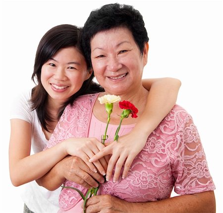 Happy Asian Mother and Daughter with carnation flower Stock Photo - Budget Royalty-Free & Subscription, Code: 400-05129442