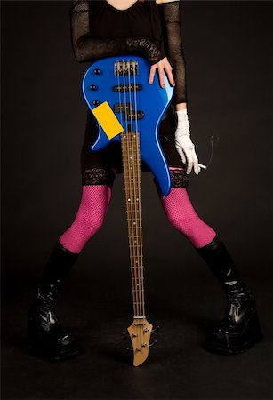 Close-up of girl with bass guitar and cigarette, studio shot Photographie de stock - Aubaine LD & Abonnement, Code: 400-05129666