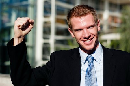 phartisan (artist) - Happy smiling triumphant business man with hands and arm raised to air standing outside corporate head corporate office. Foto de stock - Royalty-Free Super Valor e Assinatura, Número: 400-05129680