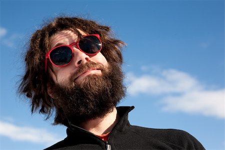 pilot pose - A funny portrait of a male with a full beard and sunglasses Stock Photo - Budget Royalty-Free & Subscription, Code: 400-05129880