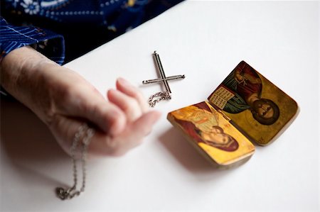 elderly praying - Religious symbolism, focus on the cross Stock Photo - Budget Royalty-Free & Subscription, Code: 400-05129892