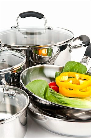 pans with glass lid - Stainless steel pots and pans isolated on white background with vegetables Stock Photo - Budget Royalty-Free & Subscription, Code: 400-05129934