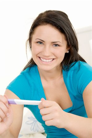 pregnant teen girl - Young Caucasian woman holding a pregnancy test Stock Photo - Budget Royalty-Free & Subscription, Code: 400-05120726