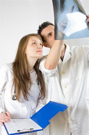 Two doctors - male and female - analysing an x-ray image of a sick patient. Stock Photo - Budget Royalty-Free & Subscription, Code: 400-05120789