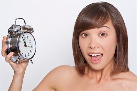 perfect timing - A naturally beautiful oriental woman make up free and holding an alarm clock just about to get to 12 o'clock Stock Photo - Budget Royalty-Free & Subscription, Code: 400-05121036