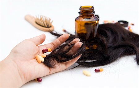 Close-up of a hand with pills and loss hair. Stockbilder - Microstock & Abonnement, Bildnummer: 400-05122126