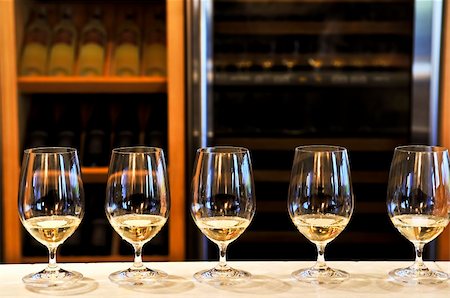 simsearch:400-04538167,k - Row of white wine glasses in winery tasting event Photographie de stock - Aubaine LD & Abonnement, Code: 400-05122136