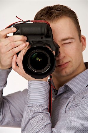 simsearch:400-04270950,k - A young man taking pictures Stockbilder - Microstock & Abonnement, Bildnummer: 400-05122416