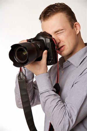 simsearch:400-04270950,k - A young man taking pictures Stockbilder - Microstock & Abonnement, Bildnummer: 400-05122410