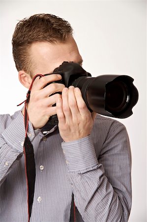 simsearch:400-04270950,k - A young man taking pictures Stockbilder - Microstock & Abonnement, Bildnummer: 400-05122412