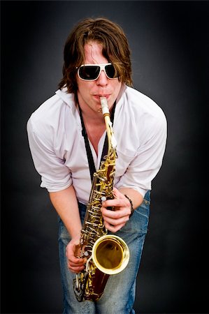 photos of man playing saxophone - A saxophone player squeezing a high note from his instrument Stock Photo - Budget Royalty-Free & Subscription, Code: 400-05123052
