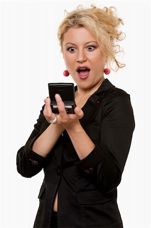 pager - Attractive blond business woman wearing business suit holding up and looking at a pager message with a shocked or surprised expression Stock Photo - Budget Royalty-Free & Subscription, Code: 400-05123503