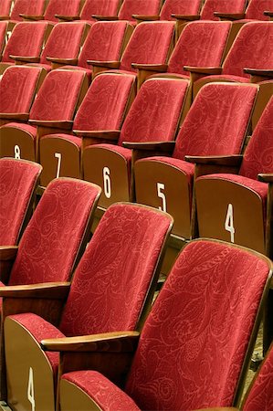 simsearch:400-09093538,k - Red cinema or theatre seats, white numbers on wooden part Photographie de stock - Aubaine LD & Abonnement, Code: 400-05123696