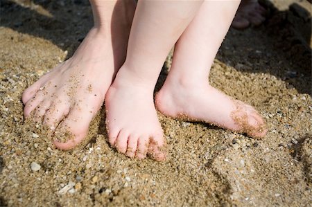 feet of child and parent on the sand Stock Photo - Budget Royalty-Free & Subscription, Code: 400-05123718