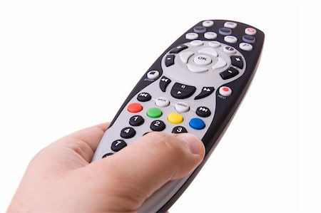 simsearch:400-05223721,k - Hand holding a tv remote control (Focus on the RGYB buttons) Foto de stock - Royalty-Free Super Valor e Assinatura, Número: 400-05123917