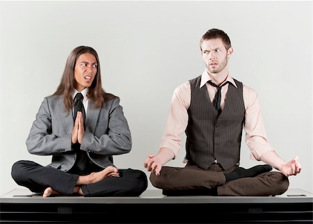 Two businessmen meditating on their office desk Stock Photo - Budget Royalty-Free & Subscription, Code: 400-05134857