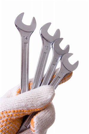 simsearch:400-08550951,k - Hand holding four chrome wrenches isolated over white Foto de stock - Super Valor sin royalties y Suscripción, Código: 400-05135219