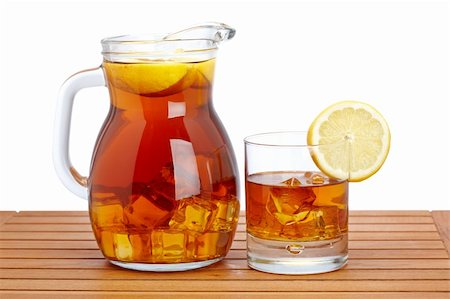 Ice tea pitcher and glasss with lemon and icecubes on wooden background. Shallow depth of field Stock Photo - Budget Royalty-Free & Subscription, Code: 400-05135234