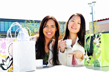 shopping spree mall - Two girl friends sitting and having drinks at outdoor mall with shopping bags Stock Photo - Budget Royalty-Free & Subscription, Code: 400-05136102