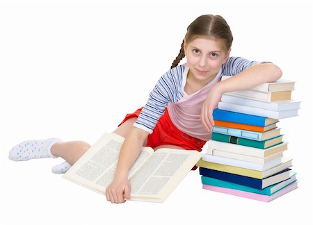 school girl holding pile of books - Girl sits having leant the elbows on a pile of books Stock Photo - Budget Royalty-Free & Subscription, Code: 400-05136194