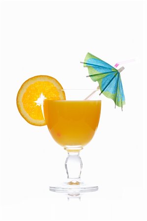 simsearch:400-04398564,k - A glass of orange juice with a slice and umbrella, isolated on white background. Shallow depth of field Stockbilder - Microstock & Abonnement, Bildnummer: 400-05136435